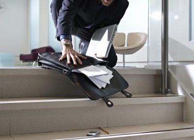 Businessman dropping briefcase on steps in office 2025 10 14 06 56 18 utc