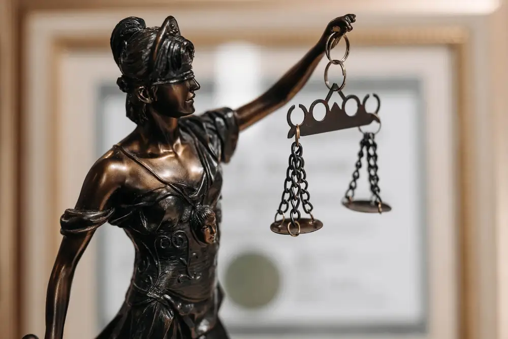 Bronze statue of Lady Justice holding the scales
